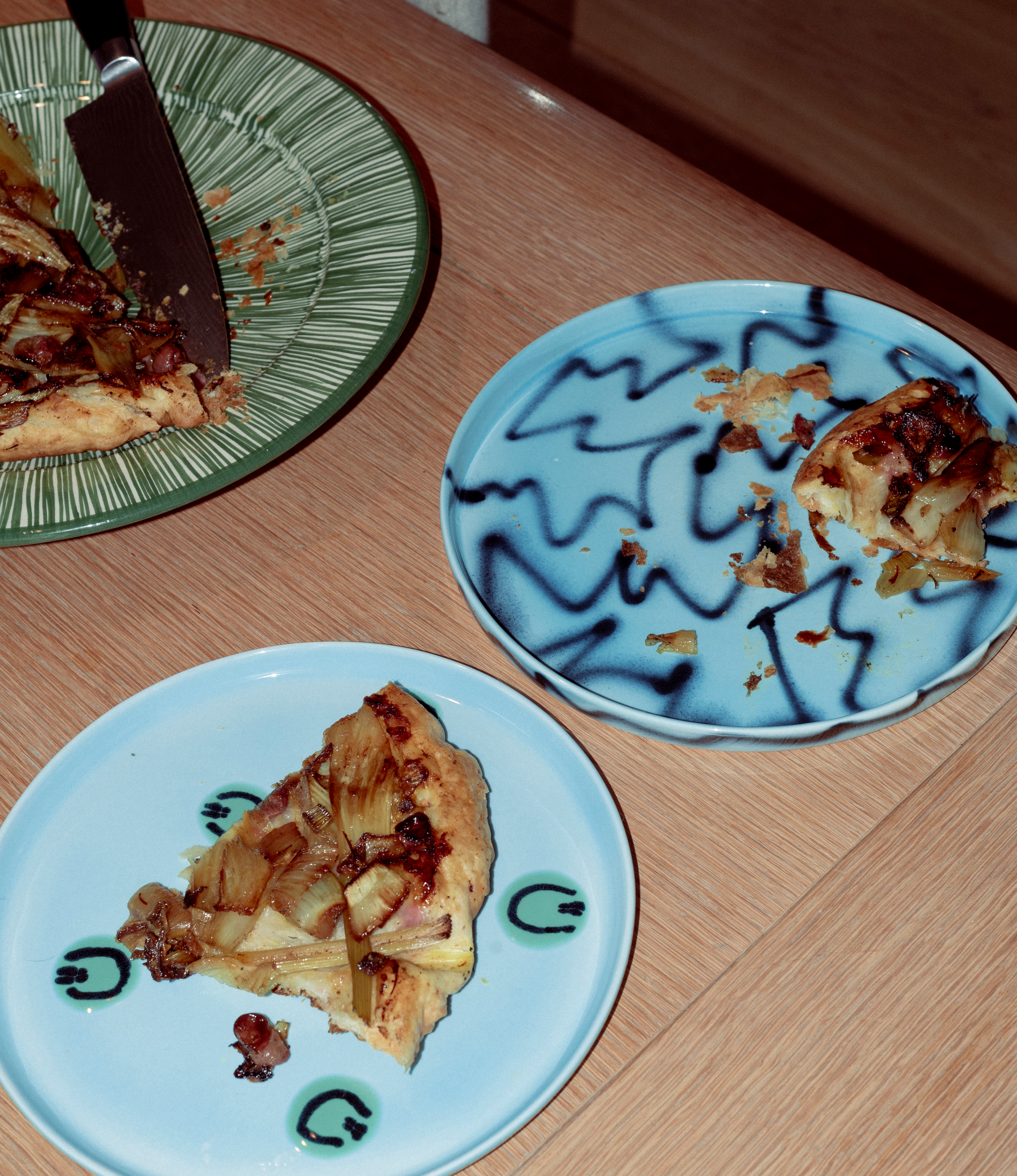 Blue Alien Plate and Blue Pizza in a kitchen setting holding fennel and grabe tarte tartin.